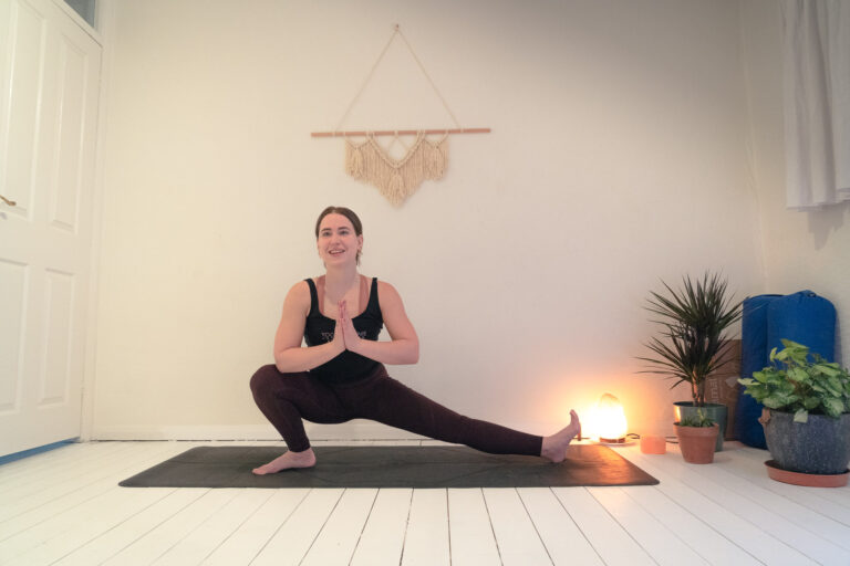 Liv Haskey Yoga Crohnie instructor smiling while in a yoga pose